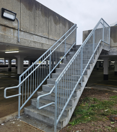 Stainless steel railings fabricated for a staircase by Coyote Bridges