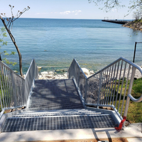 Steel stairs built and installed by Coyote Bridges beside a waterway